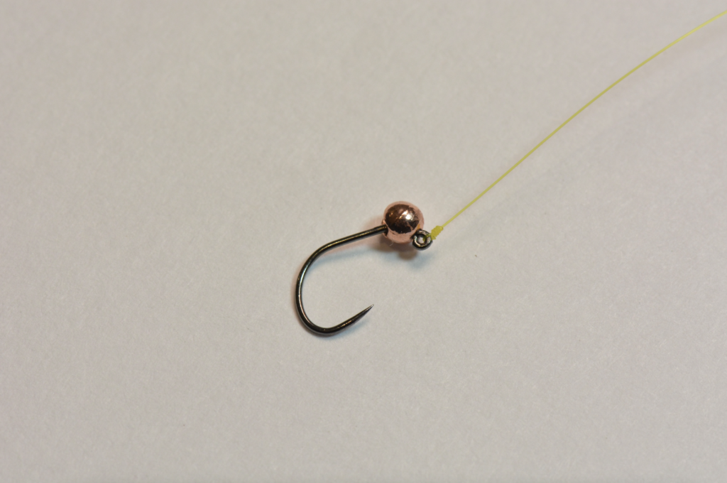 A jig hook with a tungsten bead